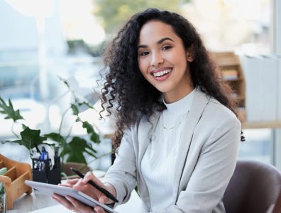 woman holding tablet representing web hosting services